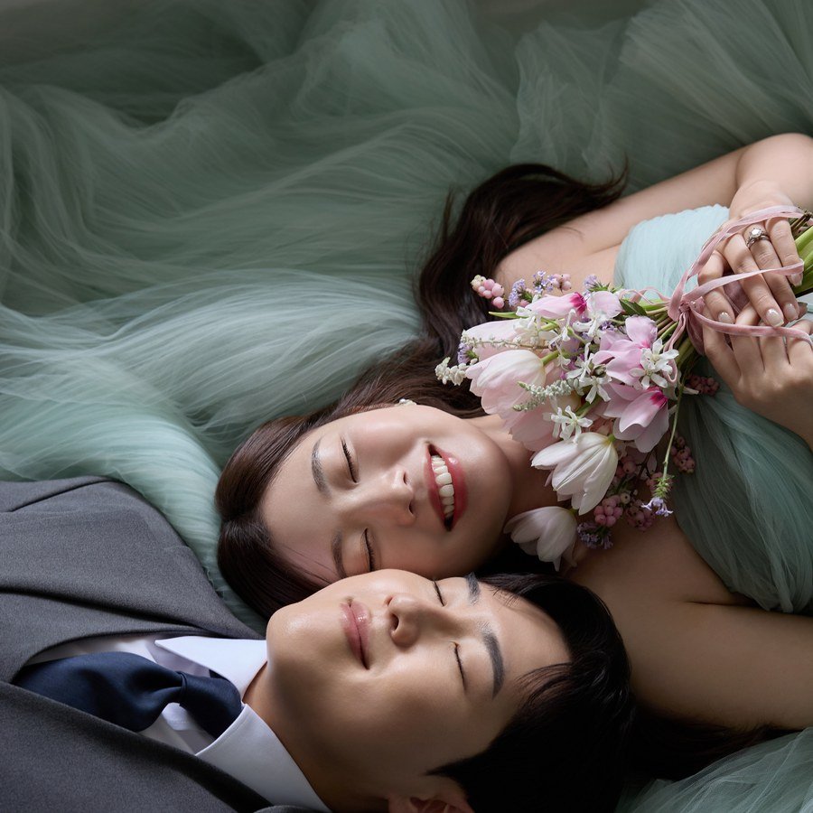 Jake and Lindsey lying together with flowers